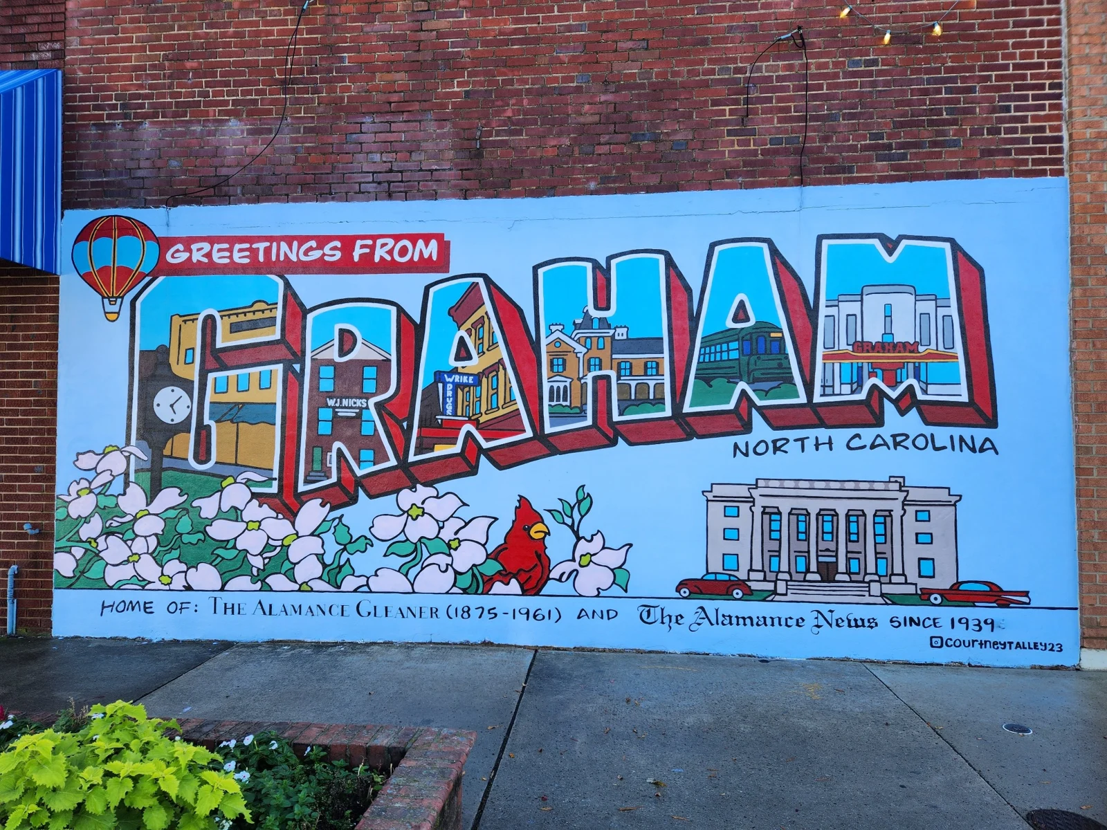 Colorful Greetings from Graham, North Carolina mural featuring local landmarks